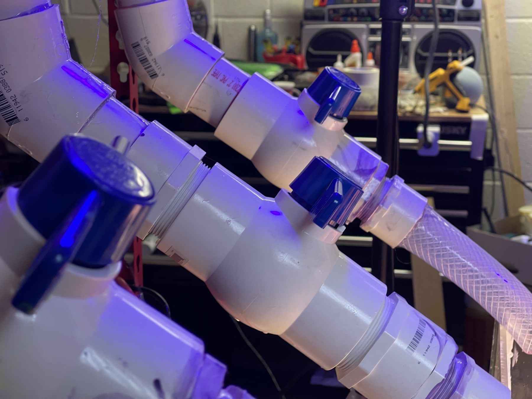 Close detail of the PVC valves, hoses and gravity-fed practical ooze rig.