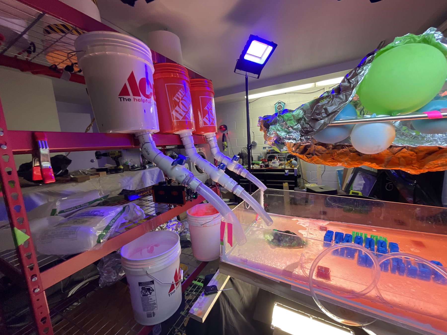 Wide view of the bucket, balloon and pipe system feeding the miniature riverbed.