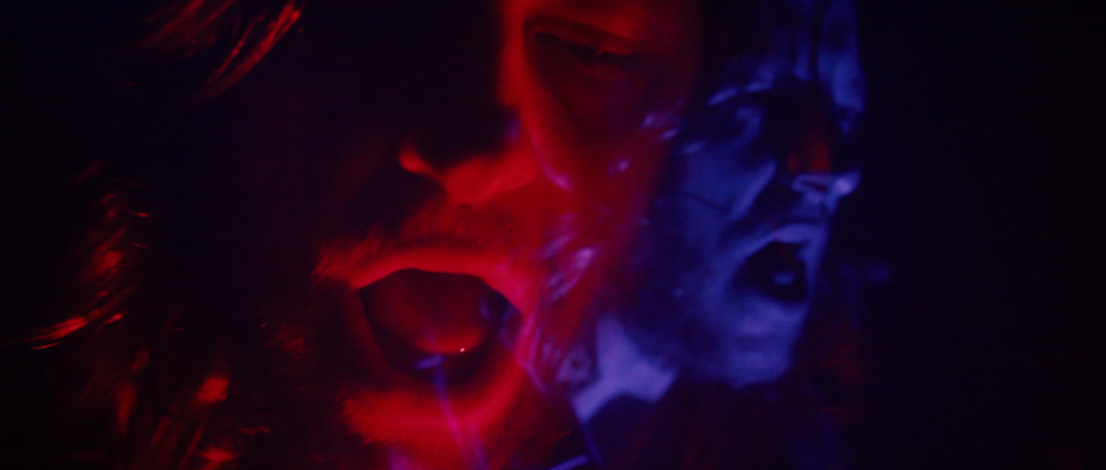 The singer doubled in red and blue as the visual language opens up.