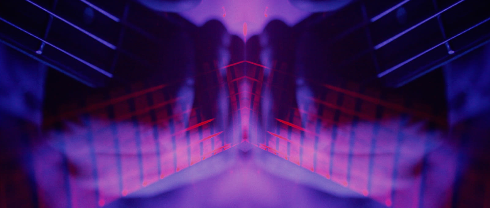 A mirrored guitar corridor in red, blue and magenta.