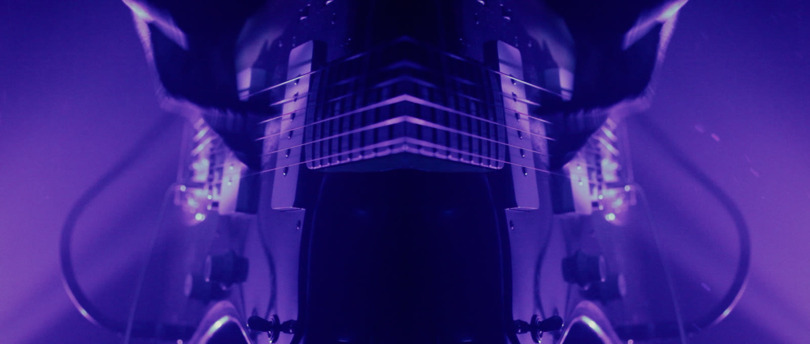 A symmetrical purple guitar image dissolving toward the outro.